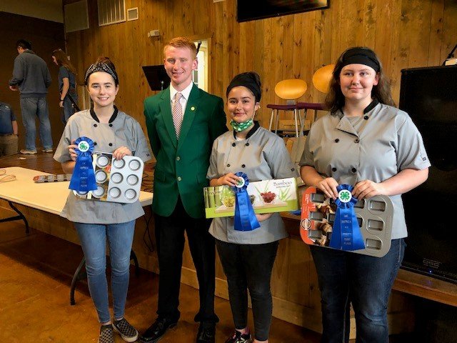 Food Challenge team members are (from left) Kierney Wallis, Helena Bautista-Mathias and Emily Swan, and presenting the awards was Cole Sullivan, District 4-H Council President.